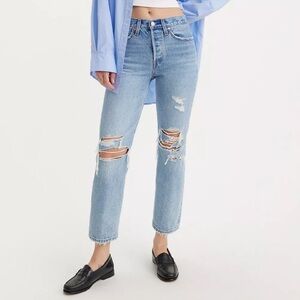 Light blue jeans with one rip